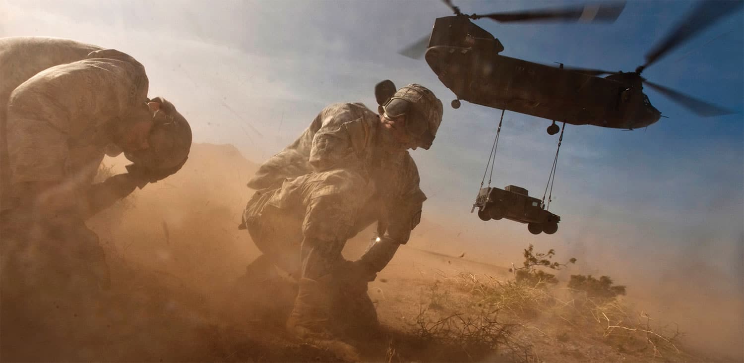 Soldiers in battle below a helicopter